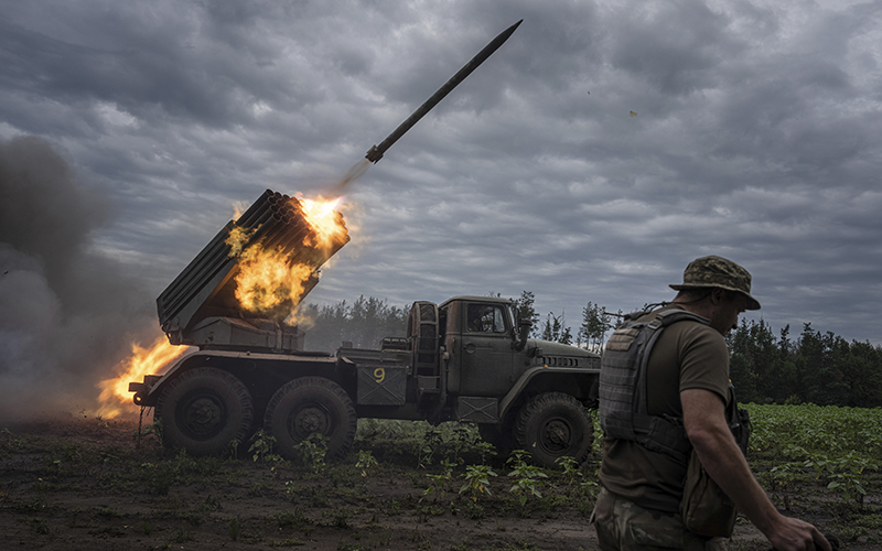 Ukrainian service members shoot a rocket
