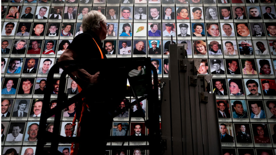 Randolph Black replaces a oak leaf picture with a portrait of Antonio Dorsey Pratt in the 9/11 Memorial & Museum on Wednesday, June 29, 2022 in New York.