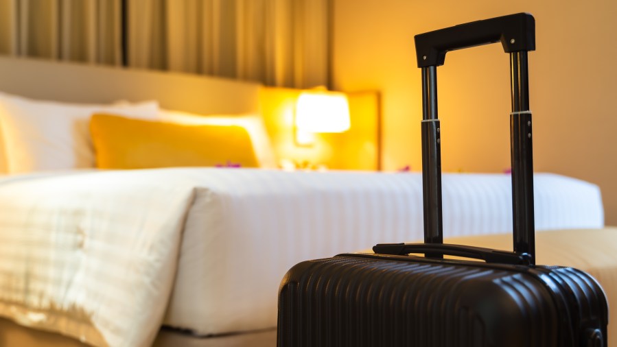 Suitcase delivered standing in hotel room. concept of Hotel service and travel - stock photo