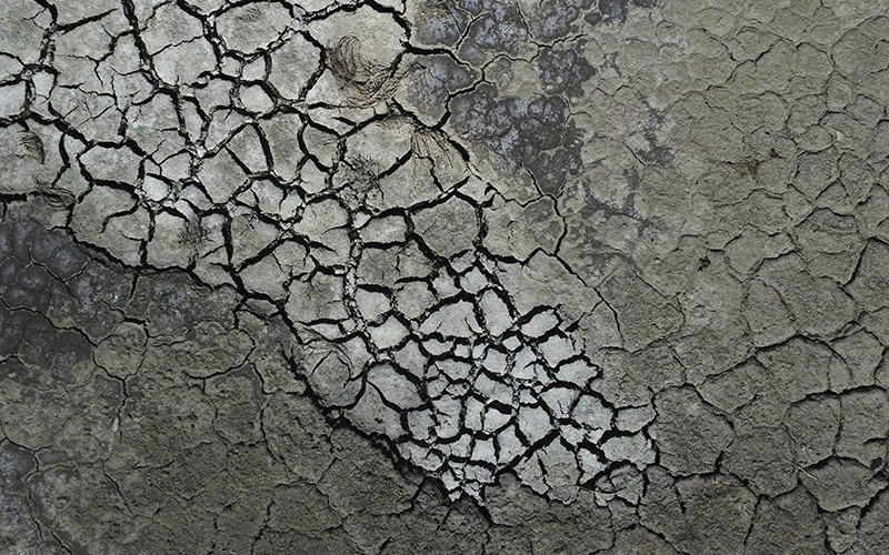 Dried cracked mud is shown at the Antelope Island Marina near Syracuse, Utah