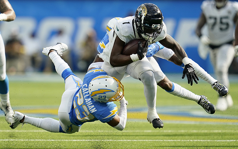 Jacksonville Jaguars running back Travis Etienne Jr. runs against Los Angeles Chargers cornerback Bryce Callahan