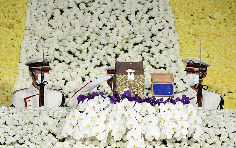 Honor guards salute a cinerary urn containing former Prime Minister Shinzo Abe's ashes