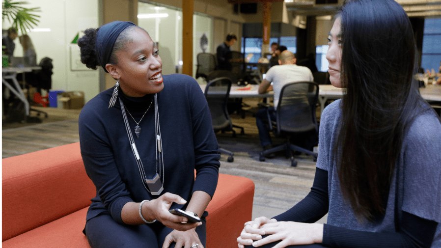 In this Tuesday, Jan. 3, 2017, photo, Aniyia Williams, founder and CEO of Tinsel, left, talks about program placement with Kara Lee, at the offices of Galvanize in San Francisco.