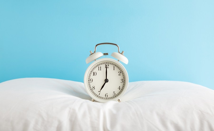 Alarm clock on pillow.