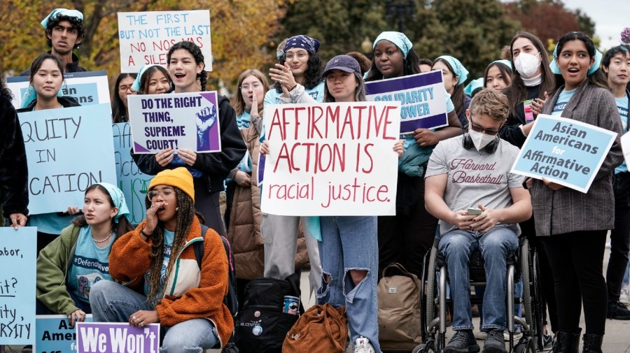 Activists demonstrate as the Supreme Court hears oral arguments on a pair of cases that could decide the future of affirmative action in college admissions, in Washington, Monday, Oct. 31, 2022.