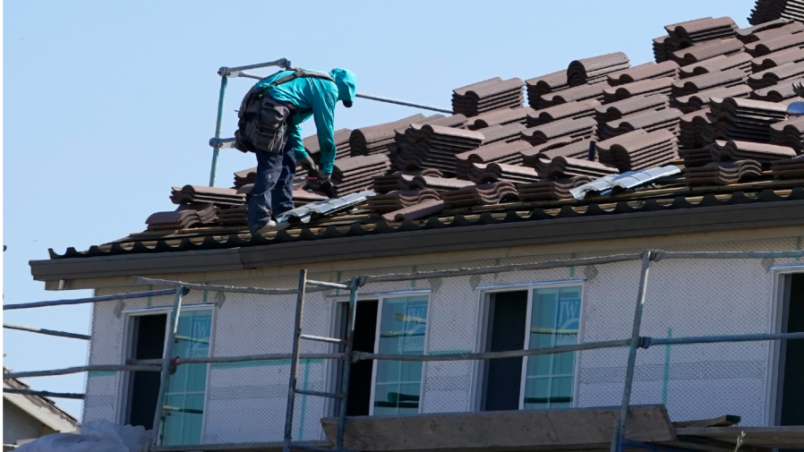 Work is performed on the roof of a home under construction in Folsom, Calif. Wednesday, Oct. 12, 2022. (AP Photo/Rich Pedroncelli)