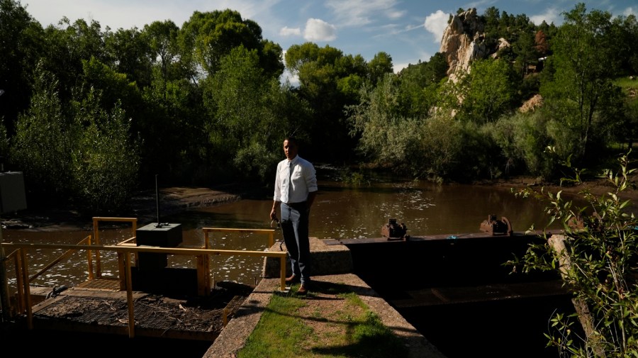 Las Vegas, N.M., city manager Leo Maestas stands at a diversion structure.