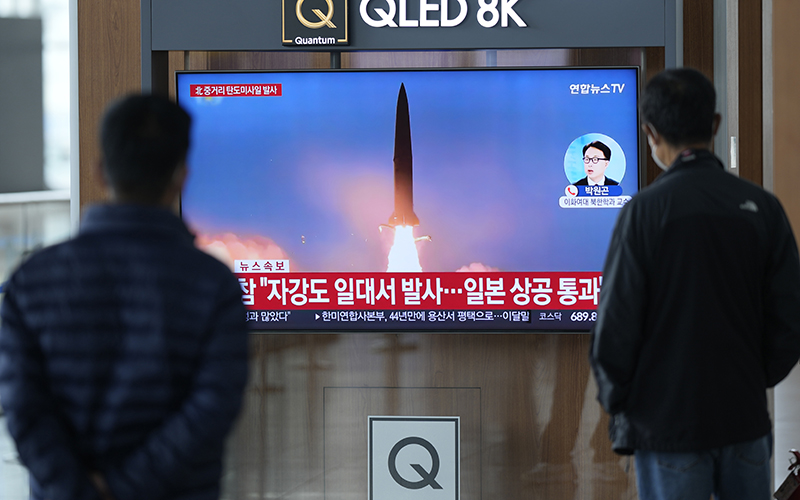 A TV screen showing a news program reporting about North Korea's missile launch