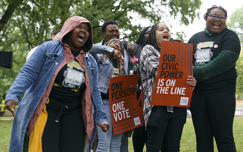 Supporters in favor of stronger voting rights chant during a rally