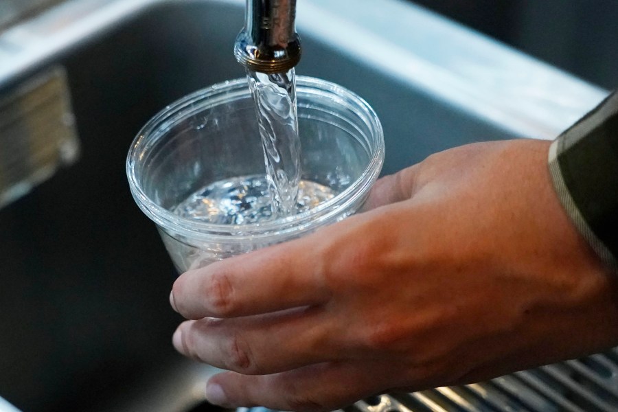 A cup of water is drawn from a faucet