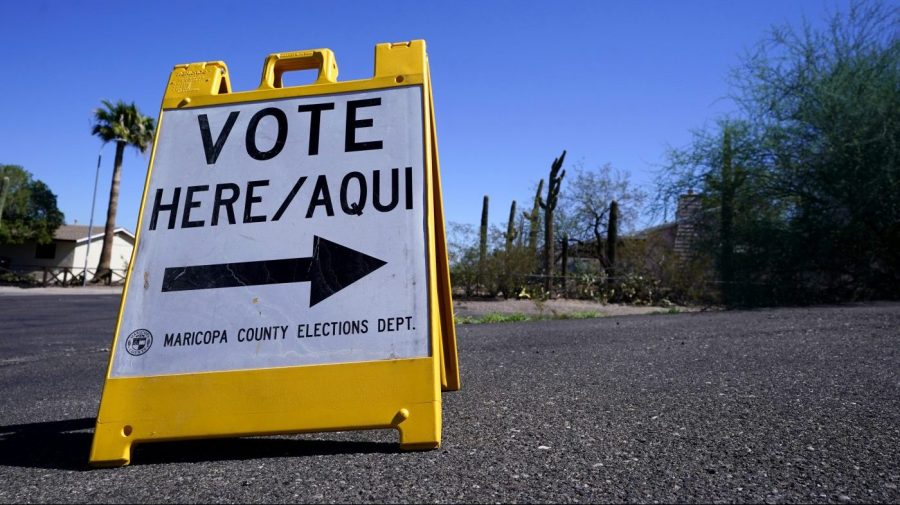 A sign marks the entrance to a voting precinct on the first day of early voting in the general election in Phoenix, Oct. 12, 2022.