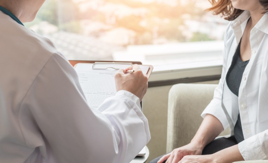 Woman and doctor in office.