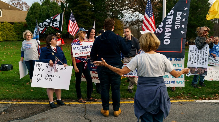 Supporters of Pennsylvania Republican candidate for Senate Doug Mastriano speaks to a supporter of Democratic candidate for Governor Josh Shapiro