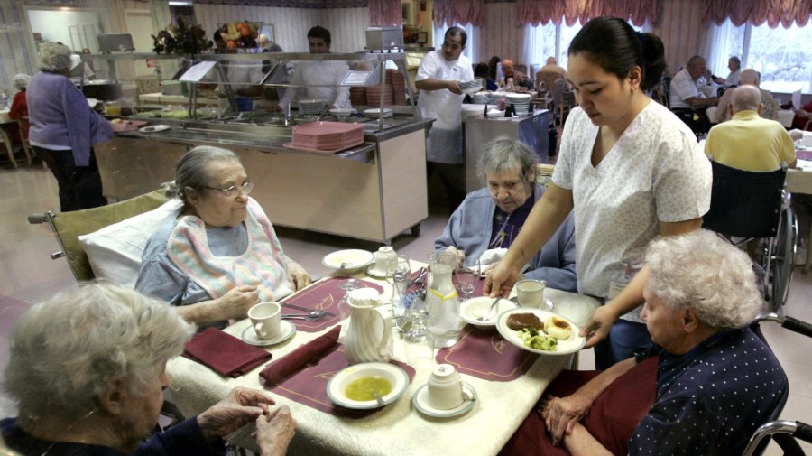 File photo - nursing home residents are served lunch at the Oak Brook Healthcare Centre in Oak Brook, Ill.