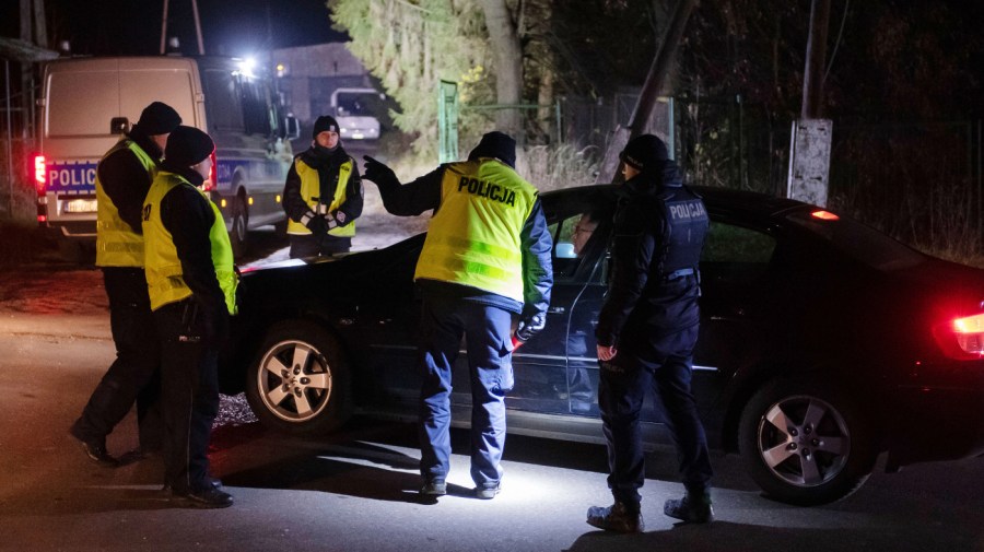 Police officers gather outside a grain depot in Przewodow, eastern Poland.