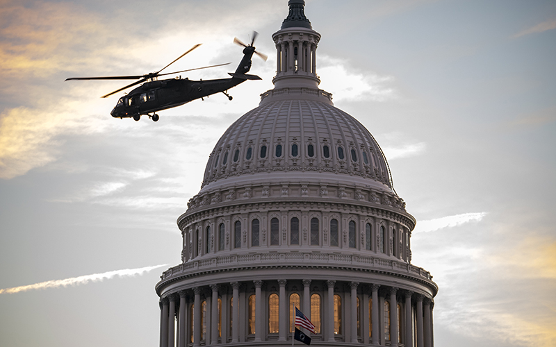 Military helicopters take off from the West Lawn of the Capitol