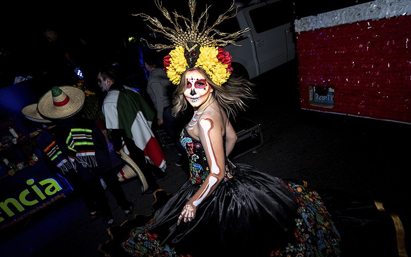 A reveler shows off her costume