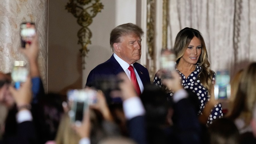 Supporters take cell phone pictures as former President Trump, left, and his wife Melania arrive for the announcement of Trump's third run for president, at Mar-a-Lago in Palm Beach, Fla., Tuesday, Nov. 15, 2022.