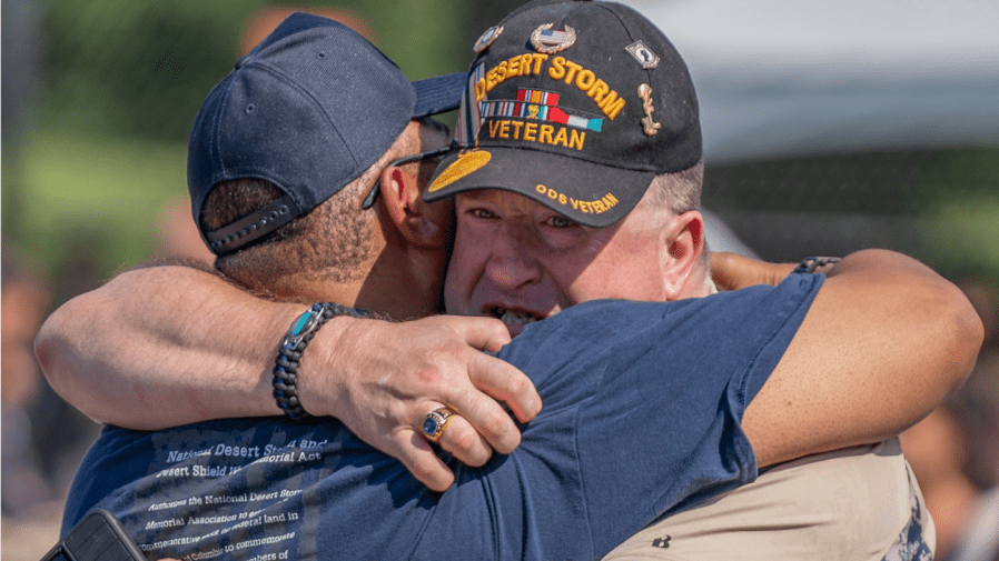 Gulf War veterans Derek Christopher Nordbye of Central Islip, N.Y., rights, becomes emotional as he hugs George Bethel of Camden Country, N.J. ahead of groundbreaking ceremony for the National Desert Storm and Desert Storm Memorial Thursday, July 14, 2022 on the National Mall in Washington.