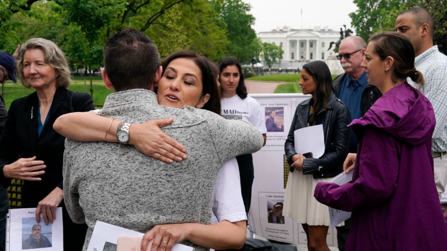 File photo - Neda Shargi, sister of Iranian prisoner Emad Shargi, hugs former Syrian hostage Sam Goodwin before a news conference with families of Americans currently being held hostage or wrongfully detained overseas in Lafayette Park near the White House, Wednesday, May 4, 2022, in Washington.