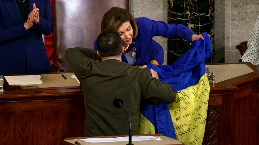 Speaker Nancy Pelosi (D-Calif.) holds a Ukrainian flag given by President Volodymyr Zelensky