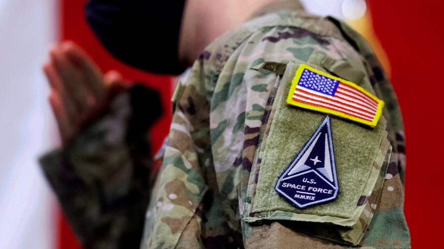 An Air Force specialist salutes in a U.S. Space Force uniform