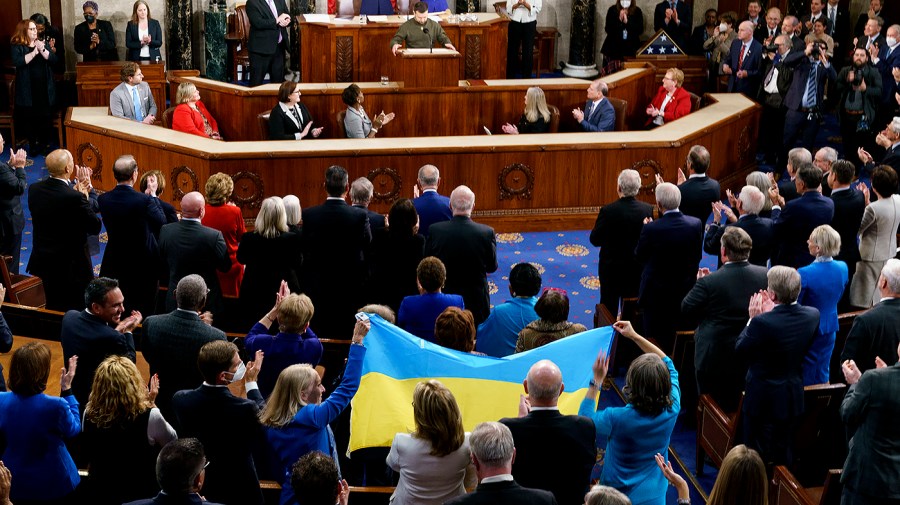 Reps. Mary Gay Scanlon (D-Pa.) and Lisa Blunt Rochester (D-Del.) hold a Ukrainian flag