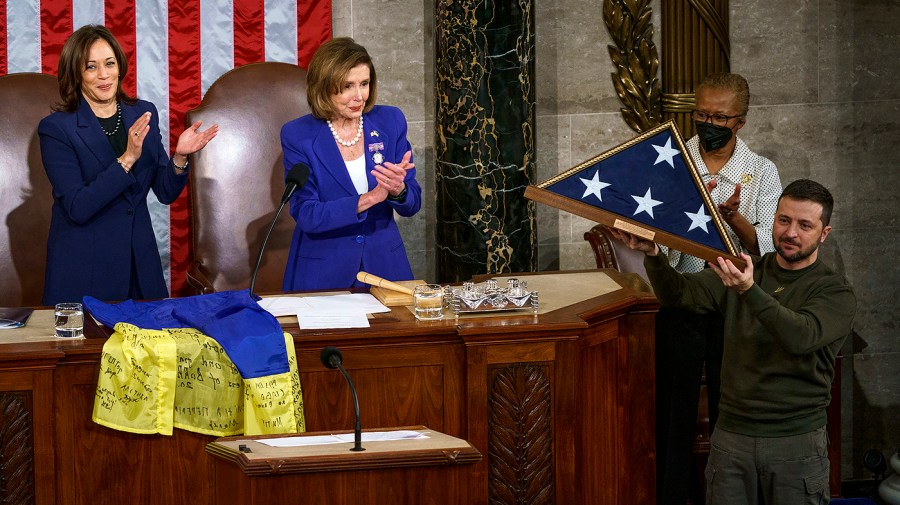 Ukrainian President Volodymyr Zelensky holds an American flag flown at the U.S. Capitol