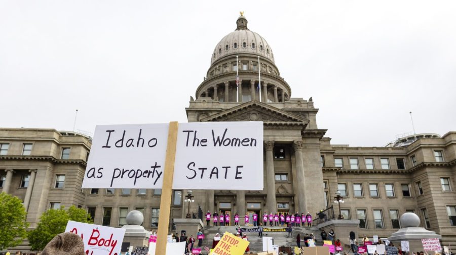 An attendee at Planned Parenthood's Bans Off Our Bodies rally for abortion rights holds a sign reading "Idaho the women as property state" outside of the Idaho Statehouse