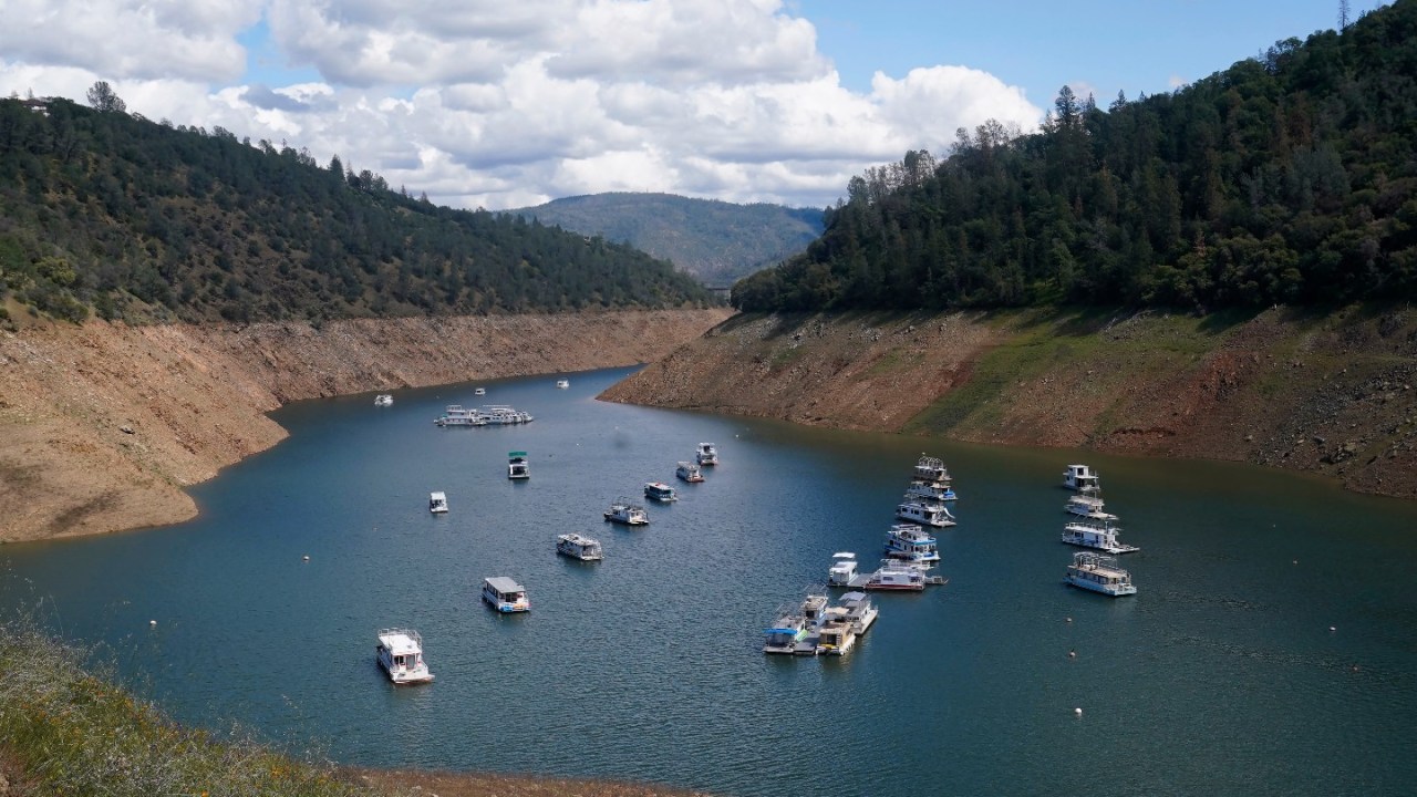 Houseboats sit in the drought lowered waters of Oroville Lake, near Oroville, Calif., Tuesday, April 19, 2022.