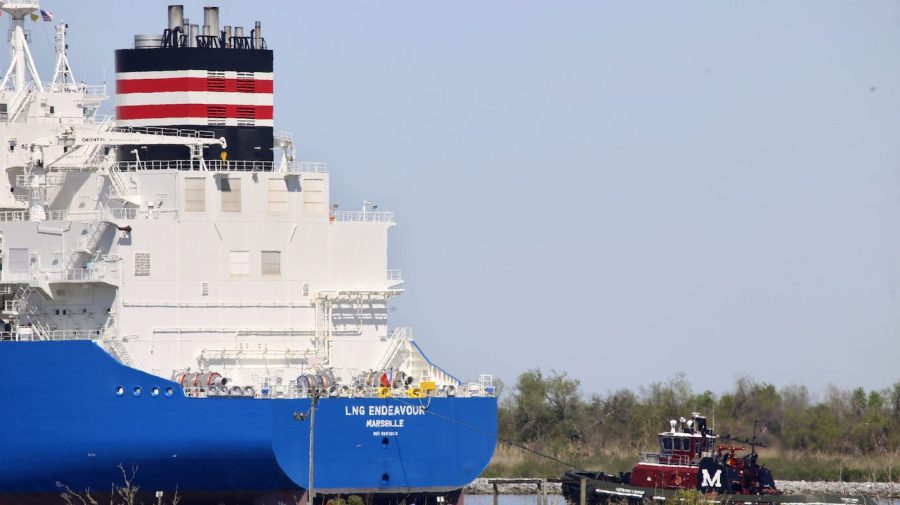 A tugboat helps guide a larger ship through a waterway.