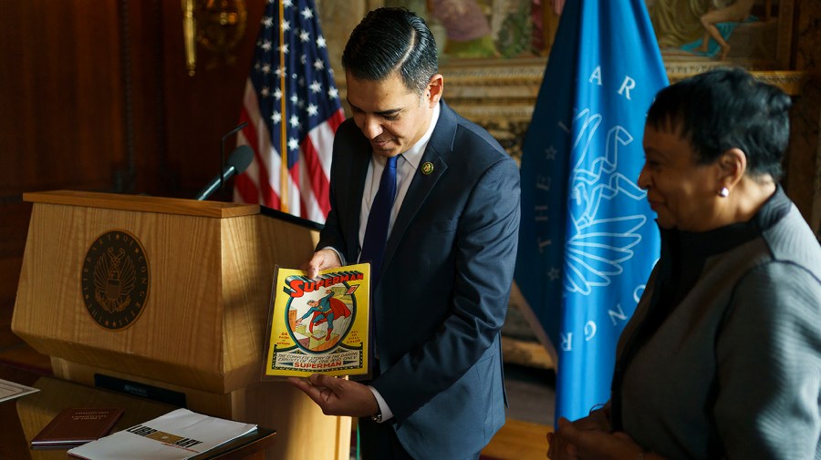 Rep. Robert Garcia (D-Calif.) holds a copy of Superman #1 at the Library of Congress