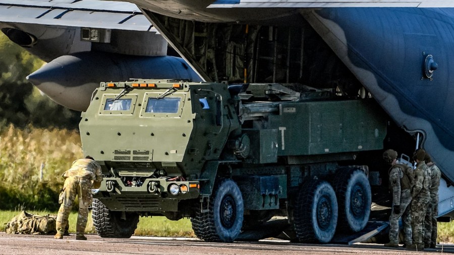 Soldiers load a High-Mobility Artillery Rocket System (HIMARS ) from a US Special Operations MC-130J aircraft