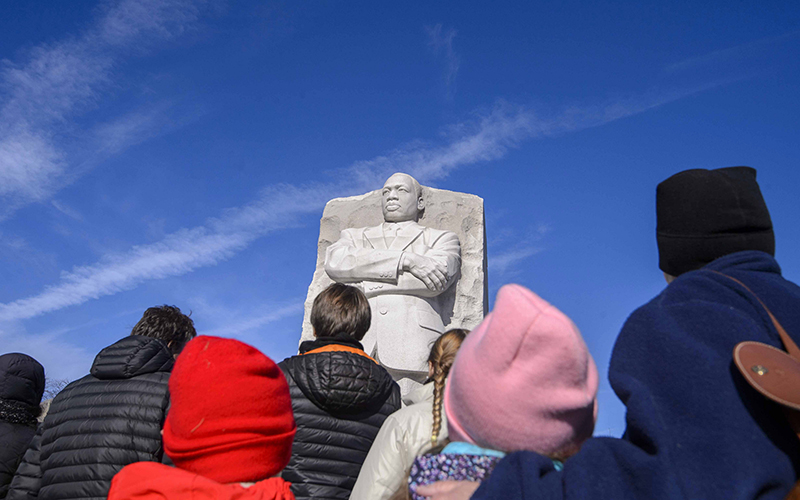 People look up at the Statue of Hope, a monument of civil rights Leader Martin Luther King Jr.