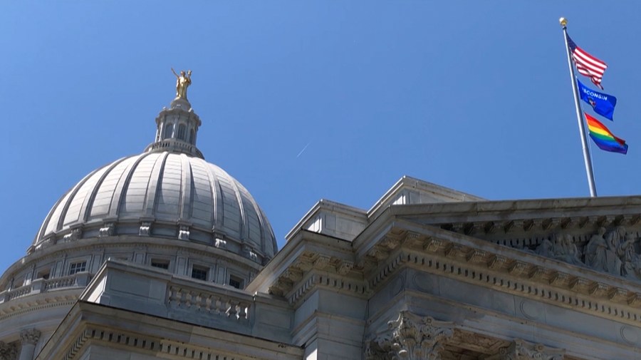 A rainbow flag observing Pride Month is displayed over the east wing of the Wisconsin state Capitol