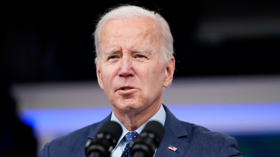 President Biden speaking into microphone