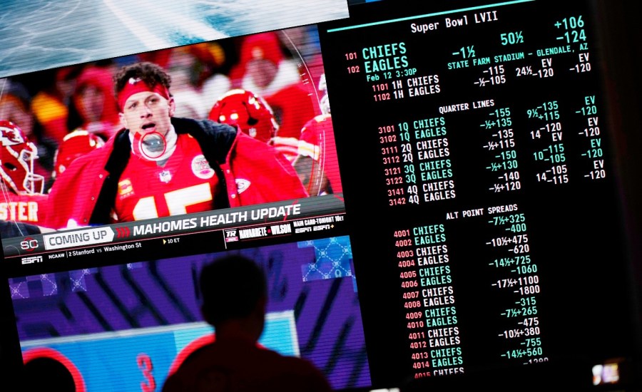 A person gambles as betting odds for NFL football's Super Bowl are displayed on monitors at the Circa resort and casino sports book Friday, Feb. 3, 2023, in Las Vegas.