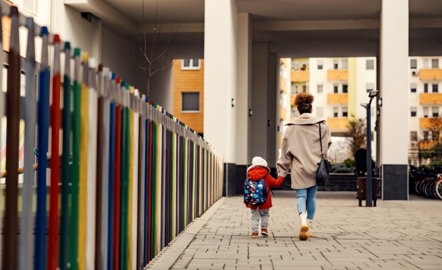 Woman walking with toddler.