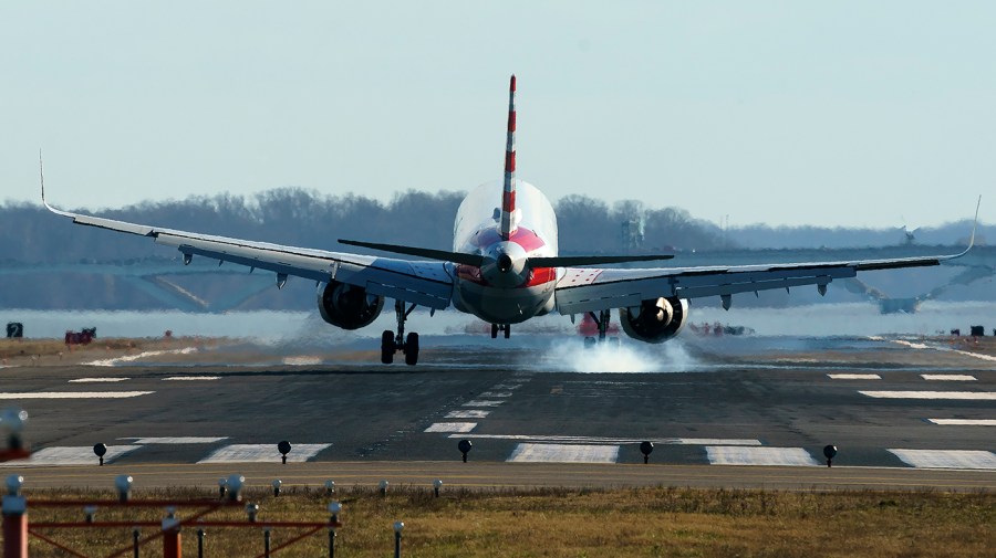 An American Airlines plane lands at Reagan National Airport in Arlington, Va.