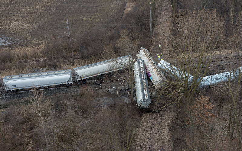 An emergency crew works at the site of a Norfolk Southern train derailment