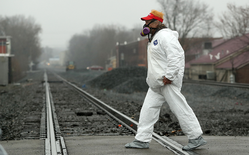 A supporter of former President Trump wears a hazmat suit and respirator