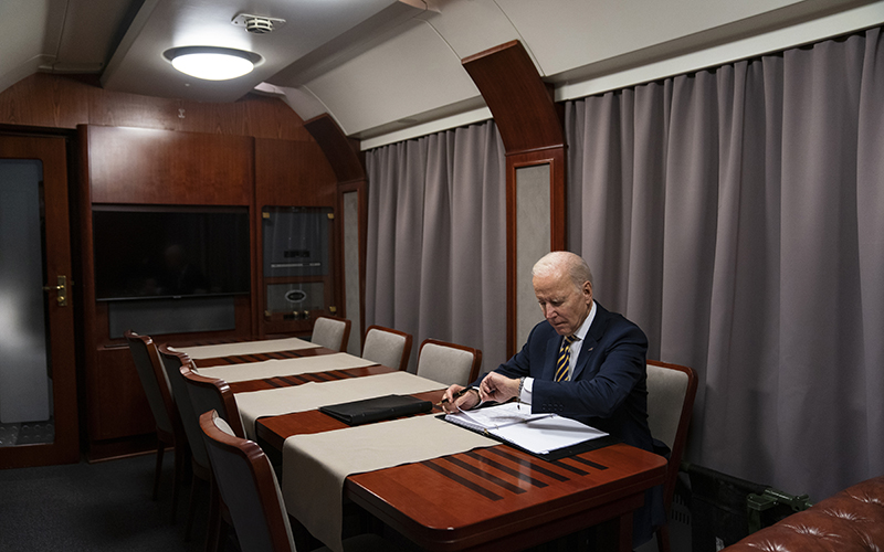 President Biden checks his watch as he goes over his speech