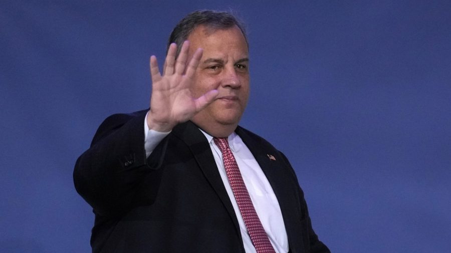 Former New Jersey Gov. Chris Christie walks on stage before speaking at an annual leadership meeting of the Republican Jewish Coalition