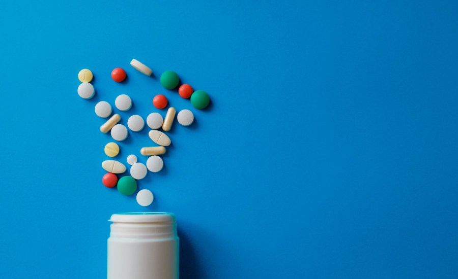 Pills falling out of bottle.