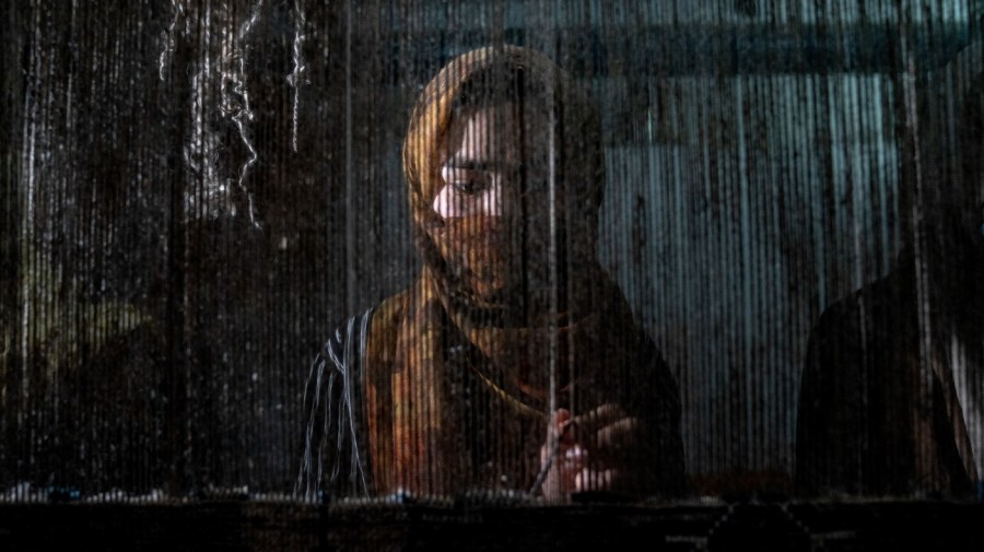 An Afghan woman weaves a carpet at a traditional carpet factory in Kabul, Afghanistan, Monday, March 6, 2023. After the Taliban came to power in Afghanistan, women have been deprived of many of their basic rights.