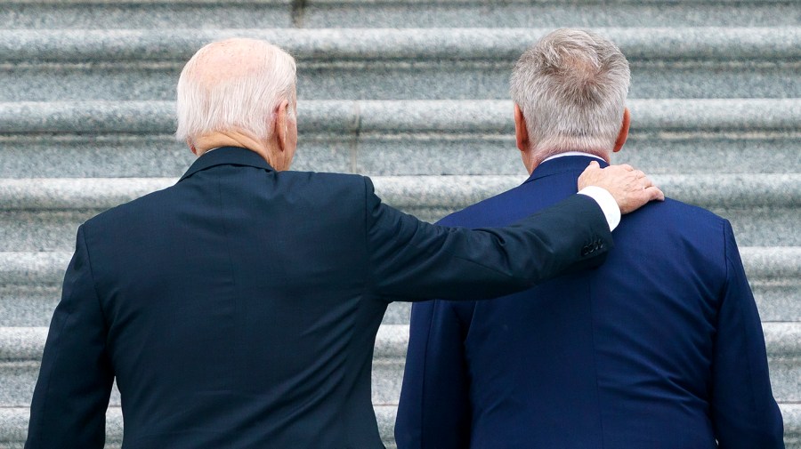 President Biden pats Speaker Kevin McCarthy (R-Calif.) on the back