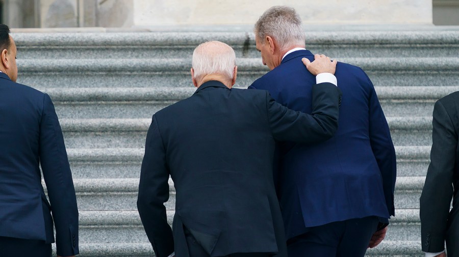 President Biden pats Speaker Kevin McCarthy (R-Calif.) on the back