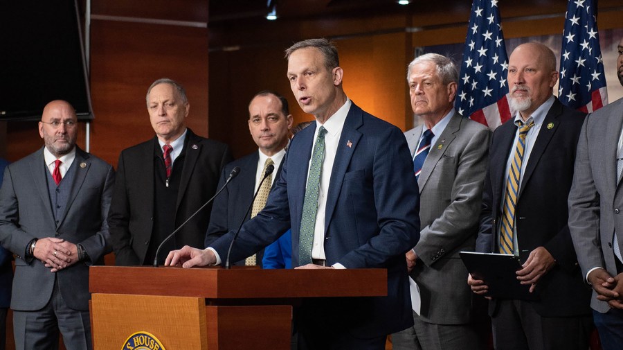 Rep. Scott Perry (R-Pa.) stands with members of the House Freedom Caucus