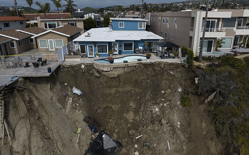 A residential swimming pool hangs on a cliffside after a landslide occurred in San Clemente, Calif.