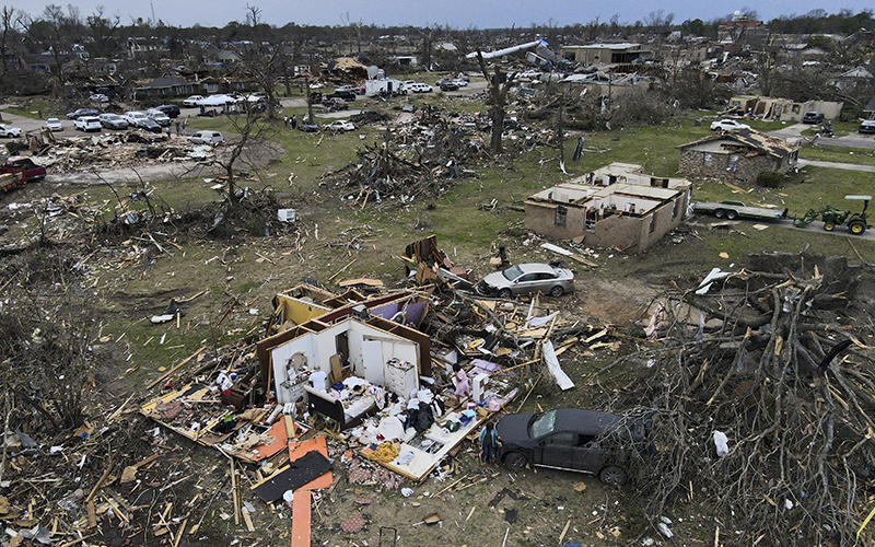 Debris is strewn about tornado damaged homes on March 26 in Rolling Fork, Miss.